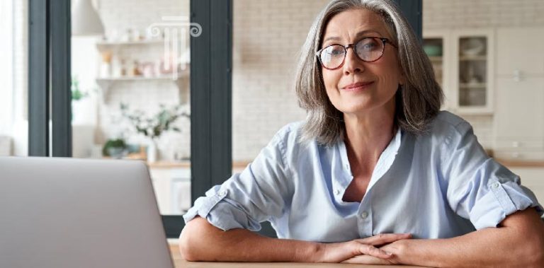 Photo of woman at desk on computer possibly considering options for hiring a tax accountant in Tennessee.