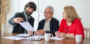 Financial planner meeting with retired couple planning on tranferring property to trust.